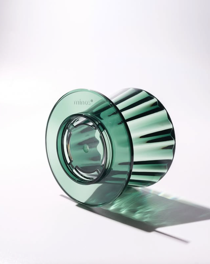 Green glass candle holder on a white background